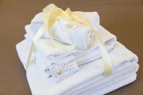 a stack of towels with a flower on them at Rooms Dream Tropea in Tropea