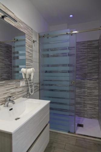 a bathroom with a sink and a shower at Rooms Dream Tropea in Tropea