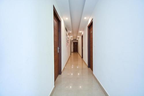 a corridor in a building with white walls and a hallway at Hotel Valley Vista in Mussoorie