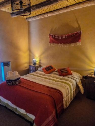 a bedroom with a bed with two towels on it at Hotel boutique Pukarainca in Uspallata
