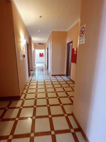 an empty hallway with a tile floor in a building at HOTEL PERLA in Massa Lombarda