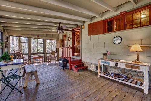a living room with a wooden floor and a clock on the wall at Rockwall in Highlands