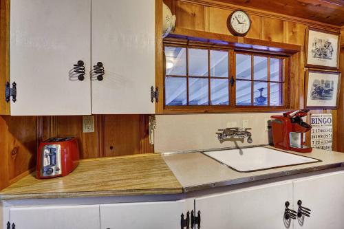 a kitchen with a sink and a red appliance at Rockwall in Highlands