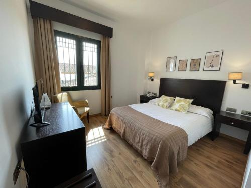 Postel nebo postele na pokoji v ubytování Hotel Cuatro Vientos