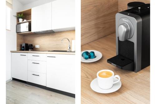 a kitchen with a microwave and a cup of coffee at Lumen Studio in Wrocław