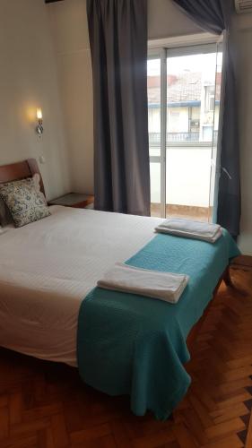 a bedroom with a large bed with a large window at Almirante 48 Two Bedroom in Lisbon