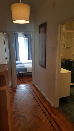 a living room with a hard wood floor and a hallway at Almirante 48 Two Bedroom in Lisbon