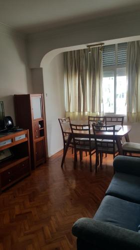 a living room with a table and chairs and a couch at Almirante 48 Two Bedroom in Lisbon