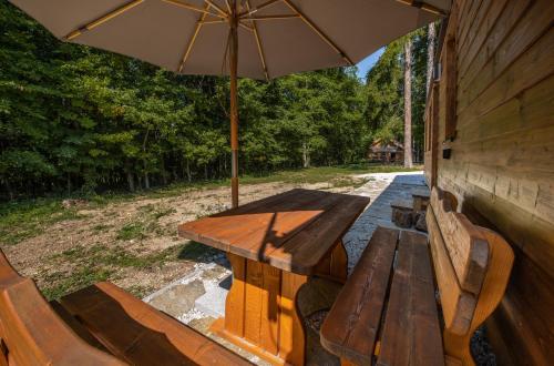 a picnic table with an umbrella on a patio at Mobile House Bojnice in Bojnice
