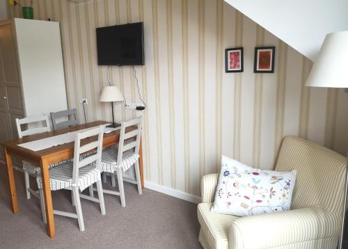 a living room with a dining room table and a chair at Nowe Guty Fun in Nowe Guty