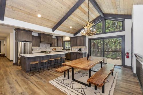 a kitchen with wooden cabinets and a table with benches at 001 - Living the Dream in Big Bear Lake