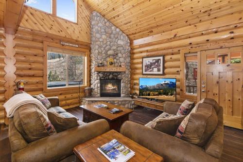 a living room with couches and a fireplace in a cabin at 004 - Bearadise in Big Bear Lake