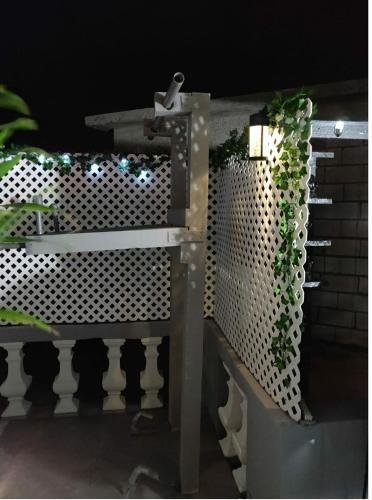 a metal fence with plants on top of it at Blue Royalty in Portmore