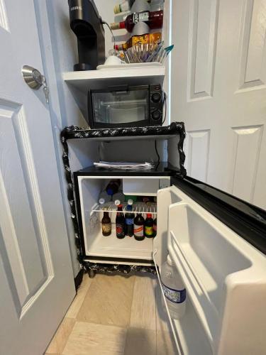 an open refrigerator filled with lots of drinks at Blue Royalty in Portmore