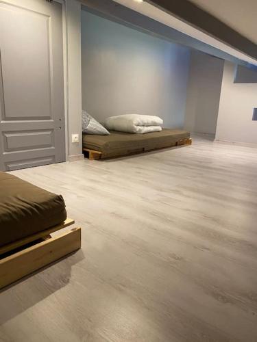 - 2 lits dans une chambre dotée de parquet et d'une porte dans l'établissement Appartement entièrement refait à neuf à 150 m de la plage, à Narbonne-Plage
