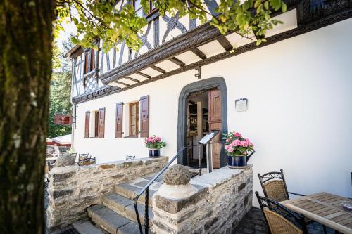 an entrance to a building with a table and chairs at Landgasthof zur Burg Grenzau in Höhr-Grenzhausen