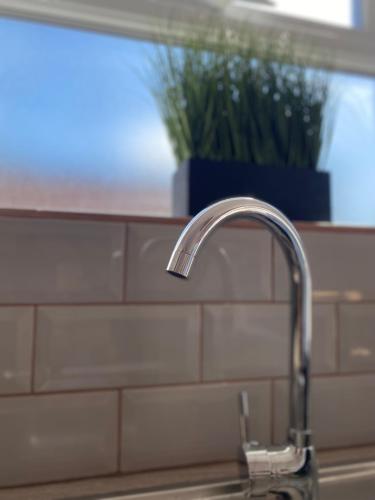 a kitchen sink with a faucet next to a window at Cosy one bed central Fareham in Fareham