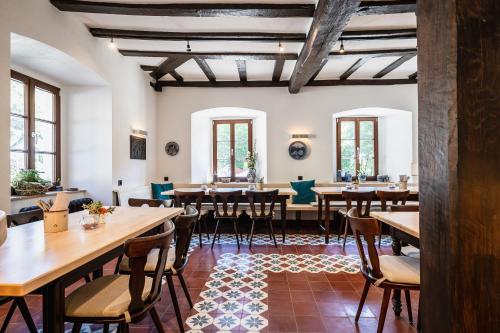 a dining room with wooden tables and chairs at Landgasthof zur Burg Grenzau in Höhr-Grenzhausen
