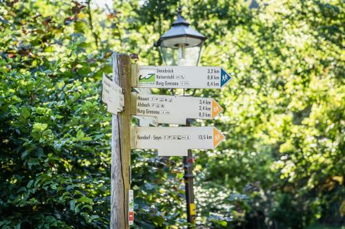 a street sign with many street signs on it at Landgasthof zur Burg Grenzau in Höhr-Grenzhausen