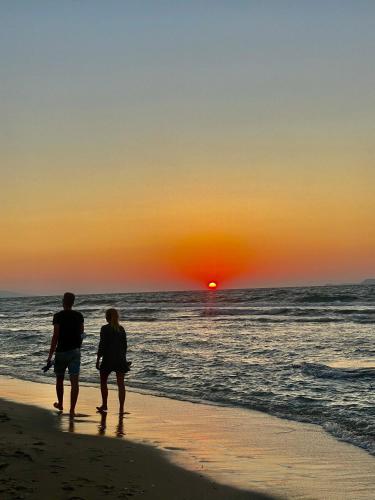 a couple walking on the beach at sunset at Mikes on the beach in Hersonissos