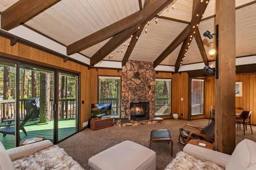 a living room with a stone fireplace in a house at 021 - Tree Fort Getaway in Big Bear City
