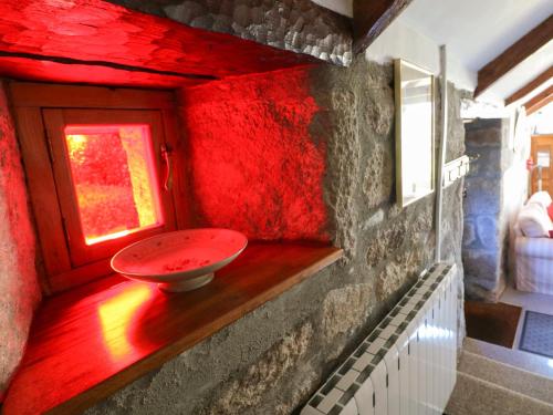 a red room with a sink in the corner of a room at Trevenning Chapel in Michaelstow