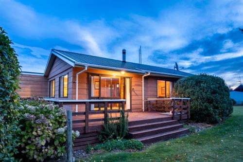 a wooden house with a porch and a deck at 4 Alpine Ave in Hanmer Springs