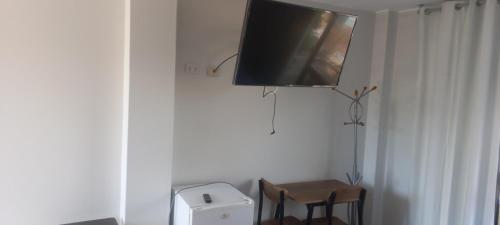 a flat screen tv hanging on the wall of a room at DEL VALLE HOUSE II in Ica