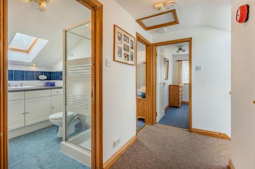 a bathroom with a toilet and a mirror at Sail Loft in Yarmouth