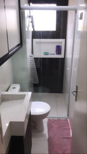 a bathroom with a sink and a toilet and a window at brisas da maré in Passo de Torres
