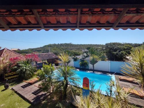 a view of the pool from the balcony of a resort at Eco suites Caravelas in Cabo Frio