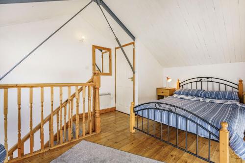 een slaapkamer met een bed en een trap bij West Sea View No 5 in Yarmouth