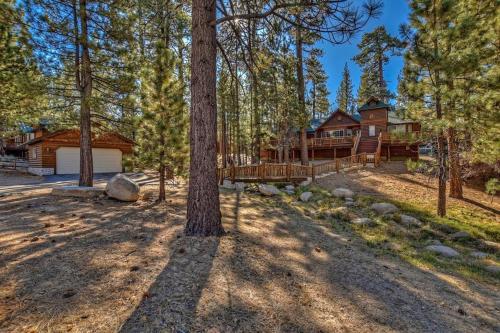 a house in the woods with a tree at 015 - Hidden Bridge Cabin in Big Bear Lake