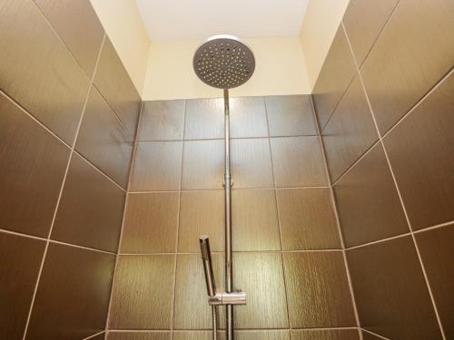 a shower with a shower head in a bathroom at Cartmel Lodge in Cartmel