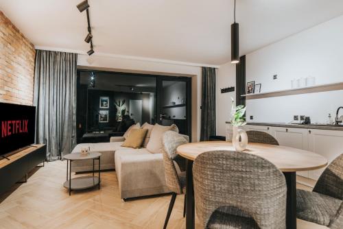 a living room with a couch and a table at Rezydencja Bieszczady - Solina in Solina