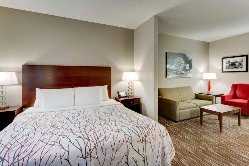 A bed or beds in a room at Best Western PLUS University Inn & Suites