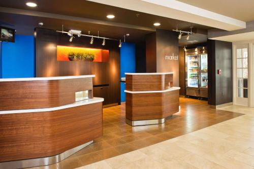 a store lobby with a counter and blue walls at Sonesta Select Tinton Falls Eatontown in Tinton Falls