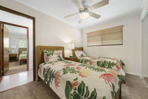 a bedroom with a bed and a ceiling fan at Ocean View 2 Bedroom Kahalu'u Reef in Kailua-Kona