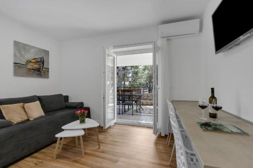 a living room with a couch and a table at Villa AMore Brela in Brela