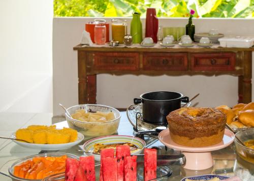 a table topped with lots of different types of food at Marezal Suítes in Pôrto de Pedras
