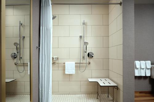 a bathroom with a shower and a sink at Hyatt Place LAX/Century BLVD in Los Angeles
