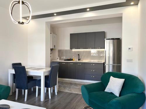 a kitchen with a table and a green couch at Heaven Premium apartments in Sarajevo