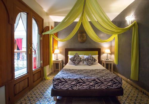 Ein Bett oder Betten in einem Zimmer der Unterkunft Riad l'Heure d'Eté