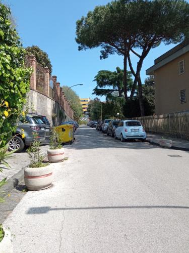 a street with cars parked on the side of the road at Relais Villa Montedonzelli in Naples