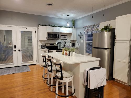 a kitchen with a white counter and a refrigerator at Just Dance in Dandridge