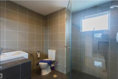 a bathroom with a toilet and a sink and a shower at KK studio [B]/2 Queen Bed/ Netflix/Free Parking in Kota Kinabalu