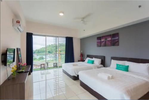 a hotel room with two beds and a large window at KK studio [B]/2 Queen Bed/ Netflix/Free Parking in Kota Kinabalu