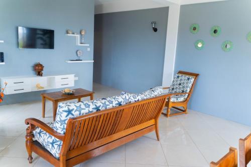 a living room with a bench and a table at Desired View in Choiseul