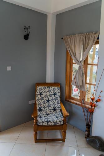 a chair sitting in a room with a window at Desired View in Choiseul