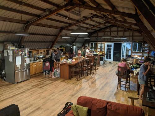 a group of people in a kitchen with tables and appliances at The Inn at Kulaniapia Falls in Hilo
